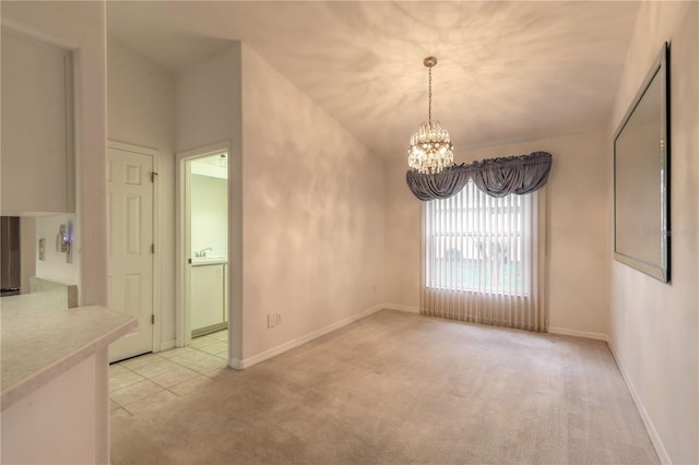 unfurnished dining area featuring baseboards, a chandelier, a sink, and light colored carpet