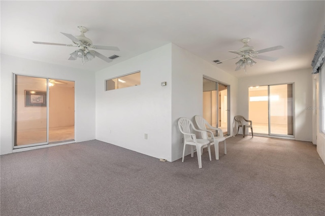 unfurnished room featuring a ceiling fan, carpet flooring, and visible vents