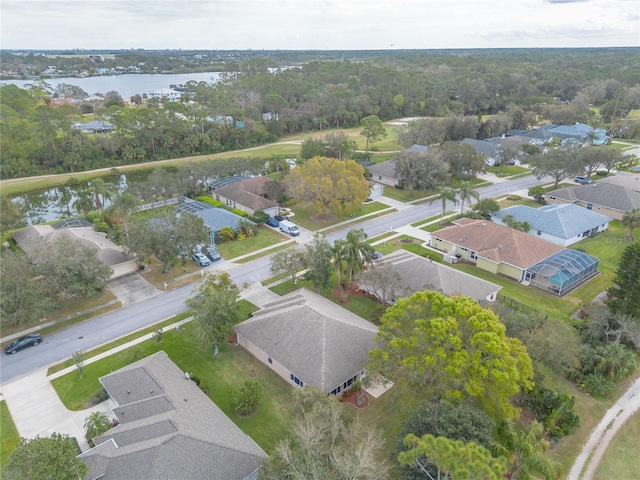 drone / aerial view featuring a water view and a residential view