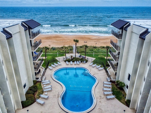 exterior space with a water view and a view of the beach