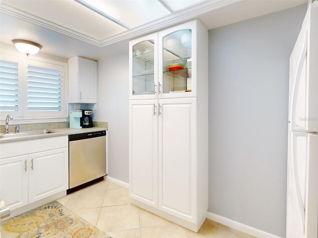 kitchen featuring light tile patterned floors, freestanding refrigerator, white cabinetry, a sink, and dishwasher