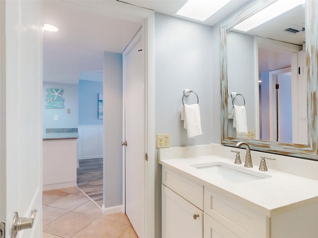 bathroom featuring visible vents, vanity, and tile patterned floors