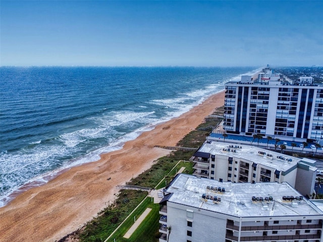 birds eye view of property featuring a beach view and a water view