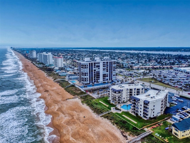 birds eye view of property featuring a water view, a view of the beach, and a city view