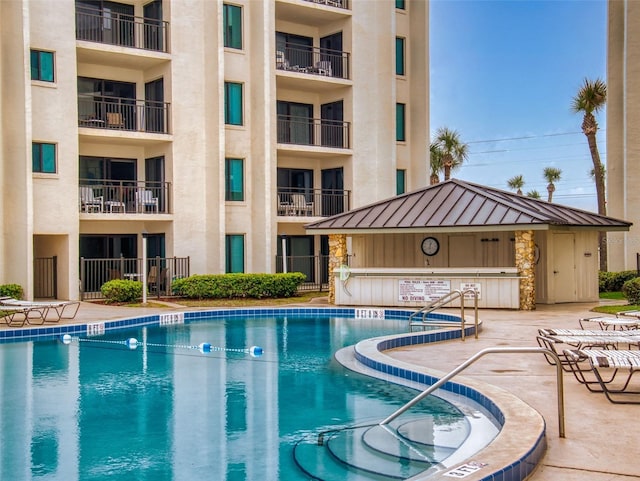 community pool with a patio area