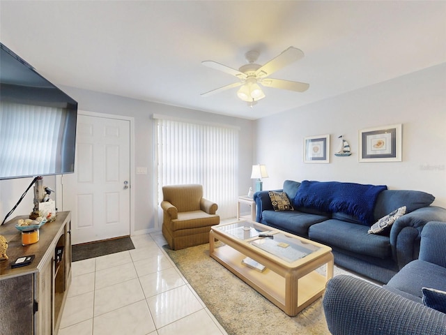 living area with light tile patterned flooring and a ceiling fan