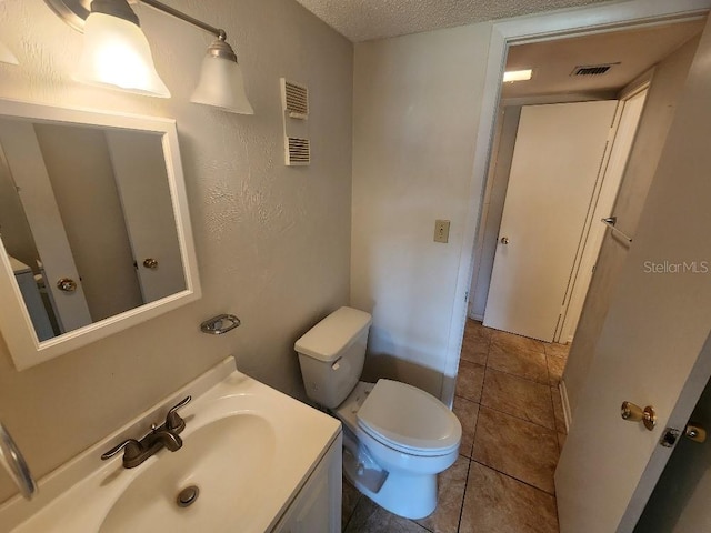 101 N Riverside Dr Unit 2090, New Smyrna Beach, FL 32168 - half bath with toilet, vanity, tile patterned flooring, and a textured ceiling