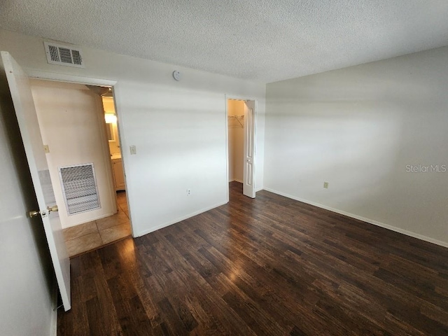 101 N Riverside Dr Unit 2090, New Smyrna Beach, FL 32168 - unfurnished bedroom featuring wood finished floors, a textured ceiling, and baseboards