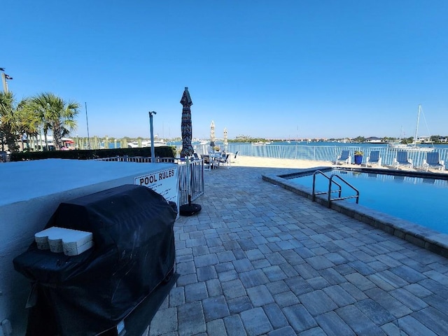 101 N Riverside Dr Unit 2090, New Smyrna Beach, FL 32168 - view of swimming pool featuring a patio area, grilling area, and a water view