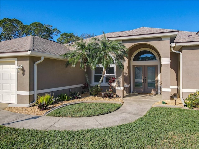 6456 Cypress Springs Pkwy, Port Orange, FL 32128 - entrance to property featuring stucco siding, french doors, a garage, and roof with shingles