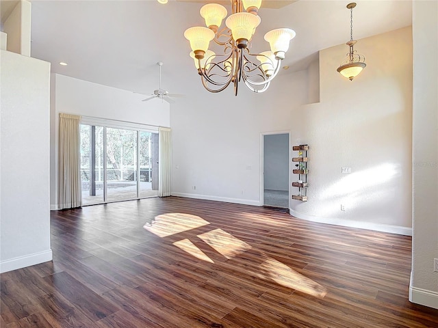 6456 Cypress Springs Pkwy, Port Orange, FL 32128 - spare room with baseboards, wood finished floors, a towering ceiling, and ceiling fan with notable chandelier