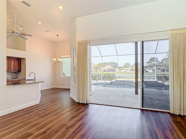 6456 Cypress Springs Pkwy, Port Orange, FL 32128 - doorway featuring dark wood-style floors, visible vents, baseboards, lofted ceiling, and ceiling fan with notable chandelier