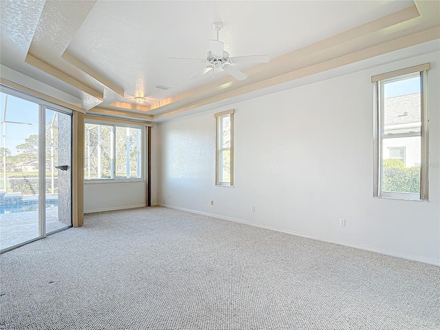 6456 Cypress Springs Pkwy, Port Orange, FL 32128 - empty room with light colored carpet, baseboards, a tray ceiling, and ceiling fan