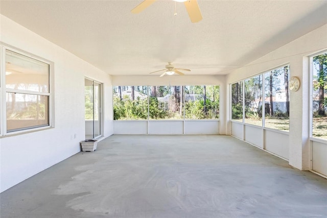 unfurnished sunroom with ceiling fan