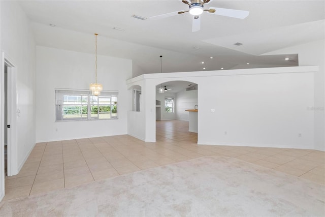 unfurnished room with tile patterned flooring and ceiling fan with notable chandelier