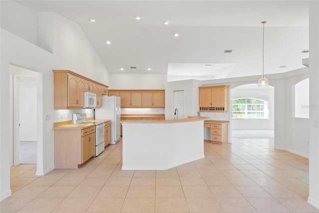 kitchen featuring white appliances, light tile patterned floors, decorative light fixtures, light countertops, and high vaulted ceiling