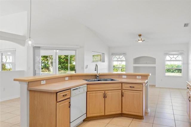 kitchen featuring light countertops, white dishwasher, a sink, and light tile patterned flooring