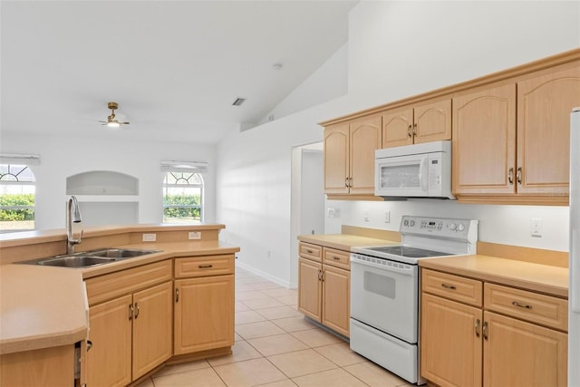 kitchen with light tile patterned floors, light brown cabinets, white appliances, a sink, and light countertops