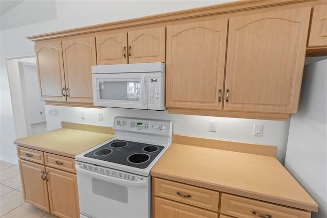 kitchen with light countertops, white appliances, light brown cabinets, and light tile patterned flooring