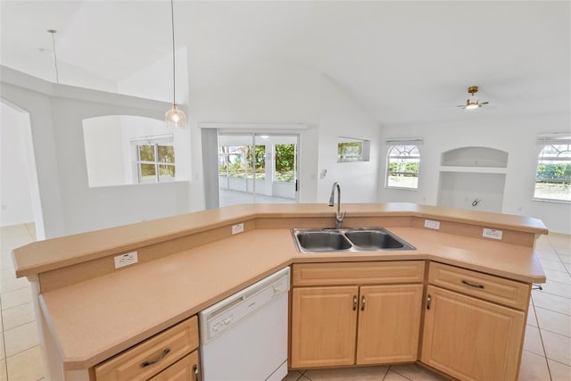 kitchen with lofted ceiling, open floor plan, white dishwasher, light countertops, and a sink