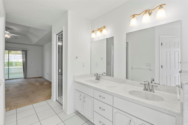 full bath featuring double vanity, a sink, a ceiling fan, and tile patterned floors