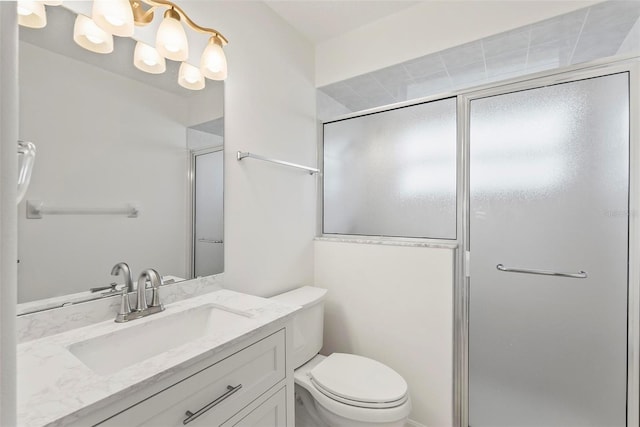 full bathroom with a shower stall, toilet, and vanity