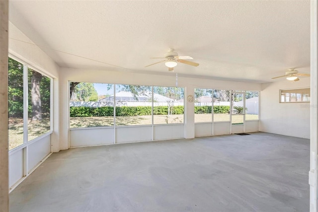 unfurnished sunroom with ceiling fan