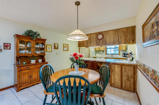 dining area with baseboards and light tile patterned floors