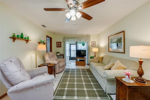 living area featuring visible vents, ceiling fan, and light tile patterned floors