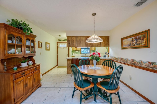 dining space with visible vents, baseboards, and light tile patterned floors