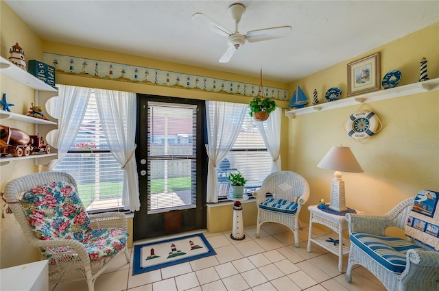 sitting room with ceiling fan and light tile patterned flooring