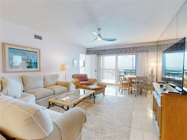 living area with light tile patterned floors, ceiling fan, and visible vents