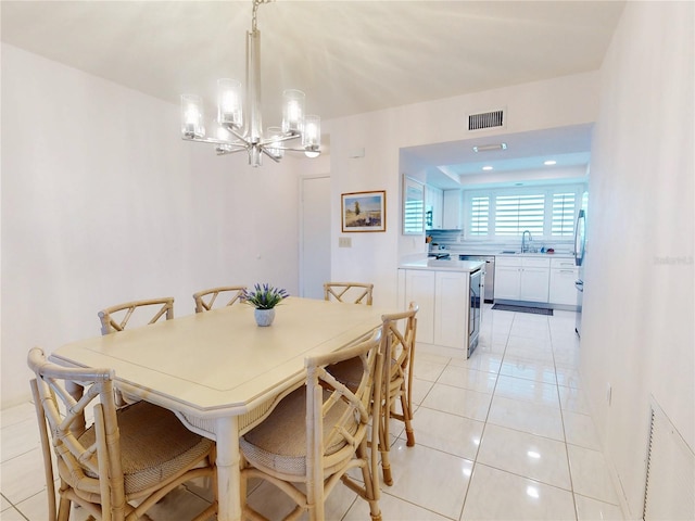 dining area with light tile patterned floors, visible vents, and a notable chandelier