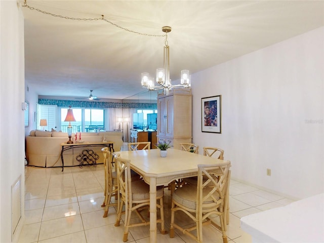 dining room with light tile patterned floors and ceiling fan with notable chandelier