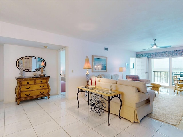 living area with visible vents, light tile patterned flooring, and a ceiling fan