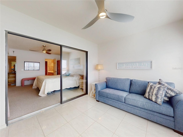 bedroom featuring ceiling fan, a closet, and light tile patterned flooring