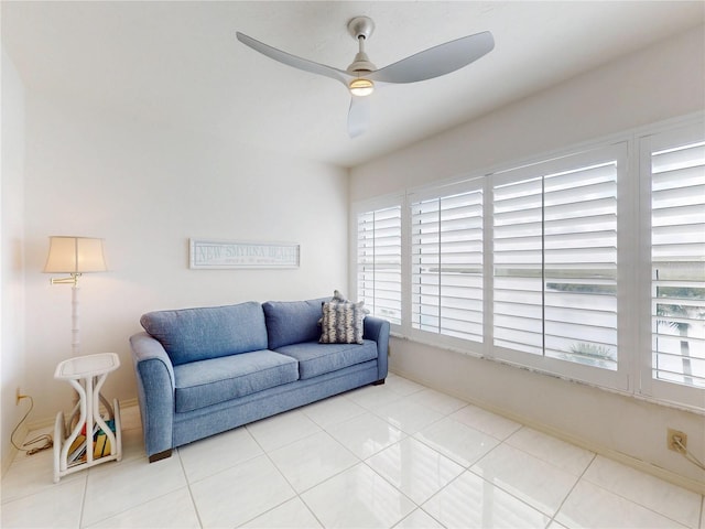 living area featuring ceiling fan and tile patterned floors