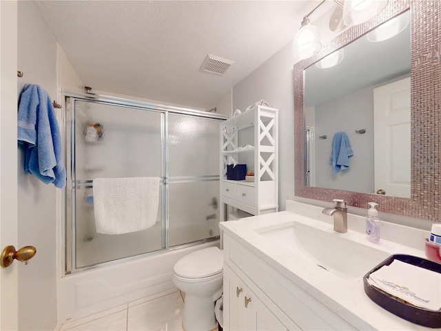 full bath with tile patterned flooring, toilet, bath / shower combo with glass door, vanity, and visible vents