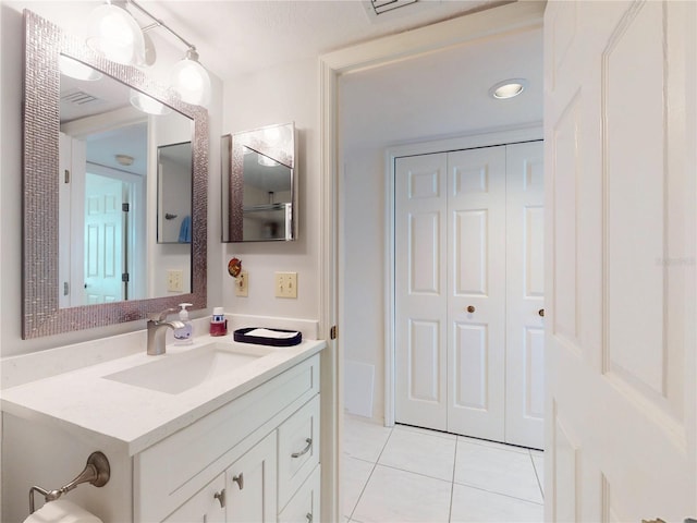 bathroom with vanity, visible vents, and tile patterned floors