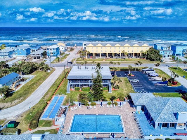 drone / aerial view with a water view and a residential view