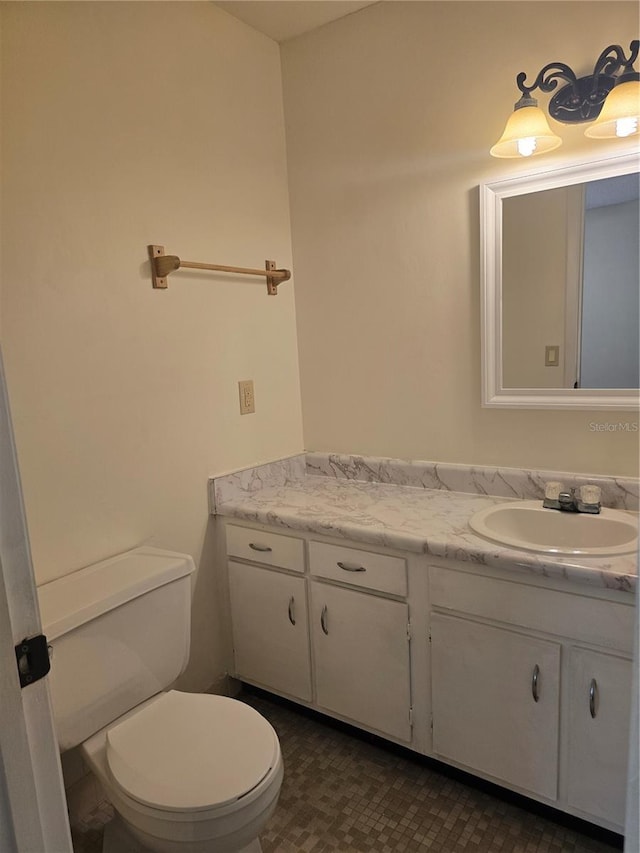 half bathroom with toilet and vanity