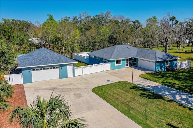 ranch-style house with a garage, driveway, fence, a front lawn, and stucco siding