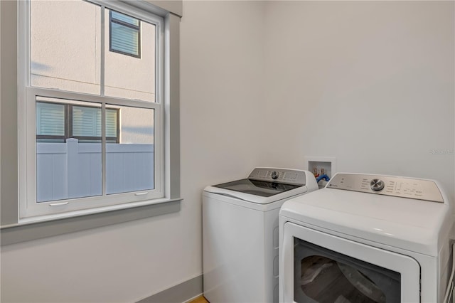 washroom featuring laundry area and separate washer and dryer