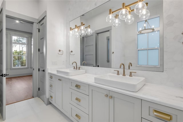 bathroom featuring a sink and double vanity