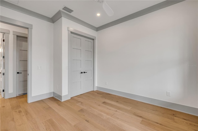 unfurnished bedroom featuring a closet, light wood-type flooring, visible vents, and baseboards