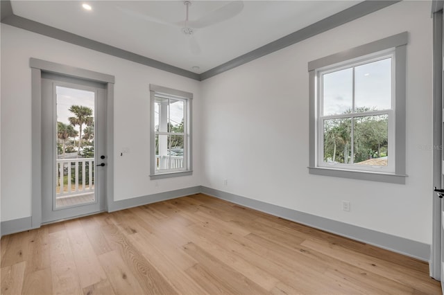 spare room featuring light wood-type flooring and baseboards