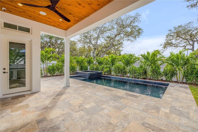 view of pool with ceiling fan, a pool with connected hot tub, and a patio