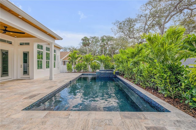 pool with a ceiling fan and a patio area