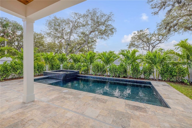 pool featuring an in ground hot tub and a patio area