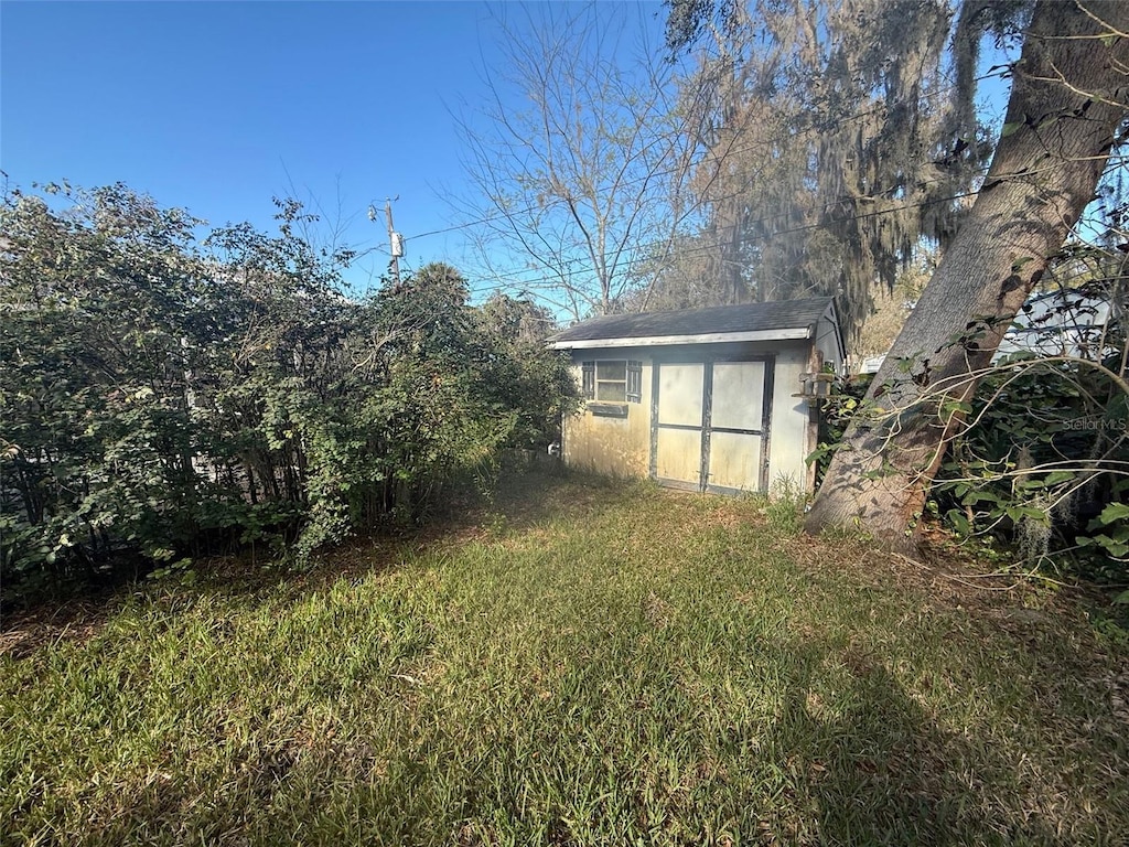 view of yard with a storage shed and an outbuilding